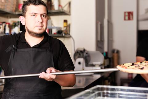 man working in traditional pizzeria